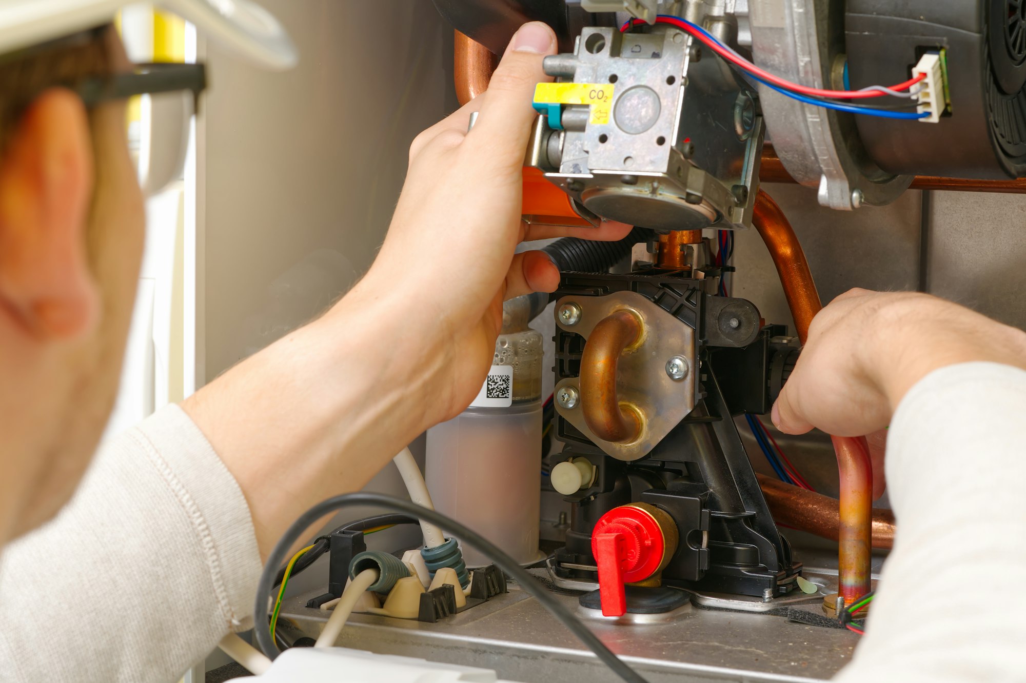 Technician servicing or Repair of a gas boiler, setting up and servicing. gas boiler for heating